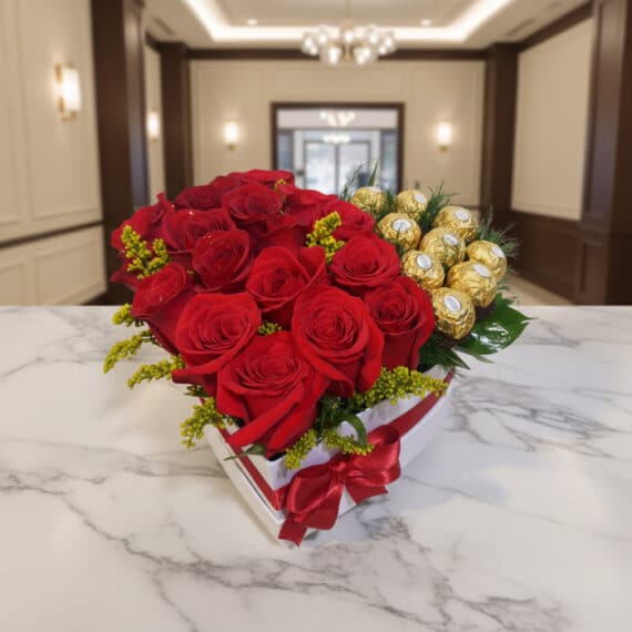 Arreglo Floral Exótico Secreto: Rosas Rojas y Ferrero Rocher Premium Arreglo floral en forma de corazón con rosas rojas vibrantes y bombones Ferrero Rocher, sobre una mesa de mármol en un elegan
